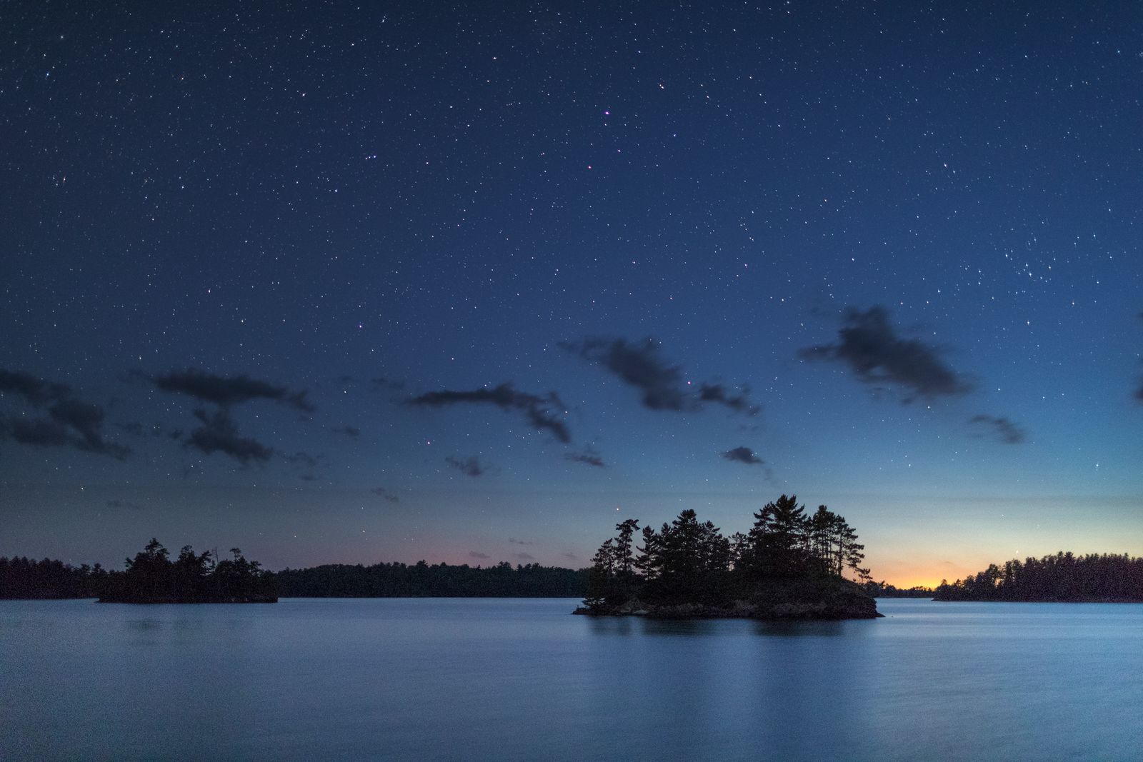 Image may contain Land Nature Outdoors Night Scenery Sea Water Sky Starry Sky Landscape Shoreline Lake and Coast