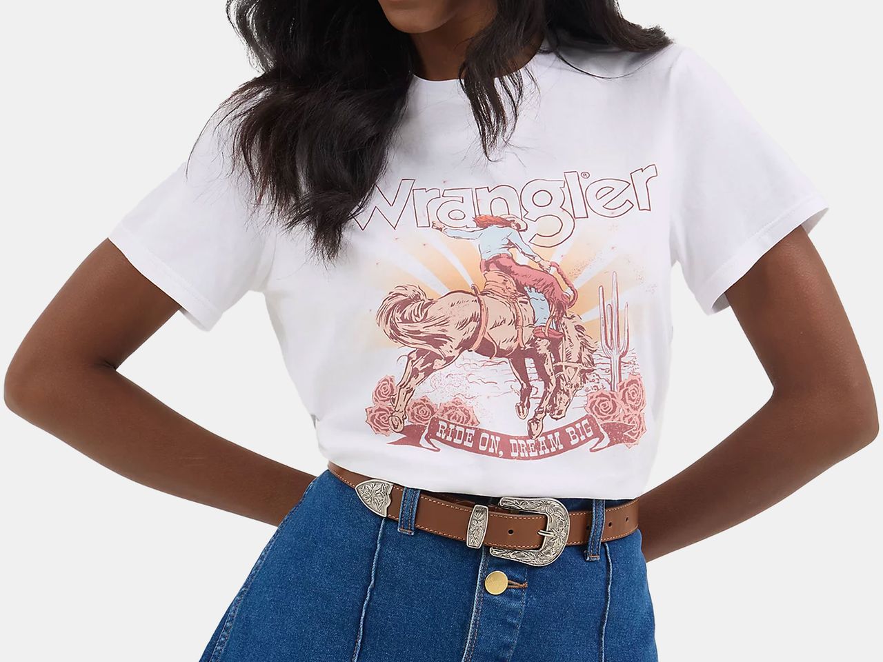 model wearing white t-shirt with colored  western graphic