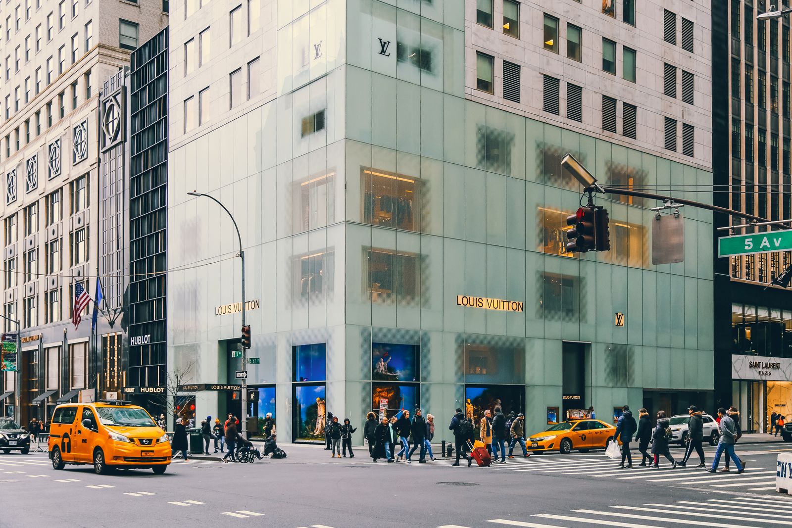 Image may contain City Urban Car Transportation Vehicle Flag Person Light Traffic Light Accessories and Bag