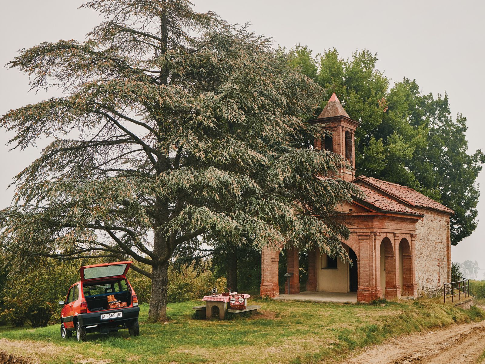 Image may contain Car Transportation Vehicle Outdoors Grass Plant Nature Arch Architecture and Gothic Arch