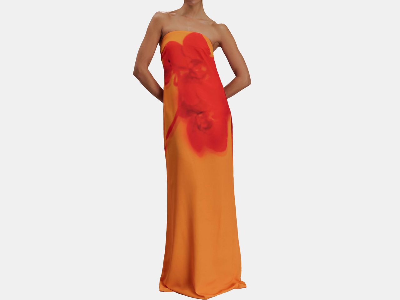 model in long orange dress with a hint of red