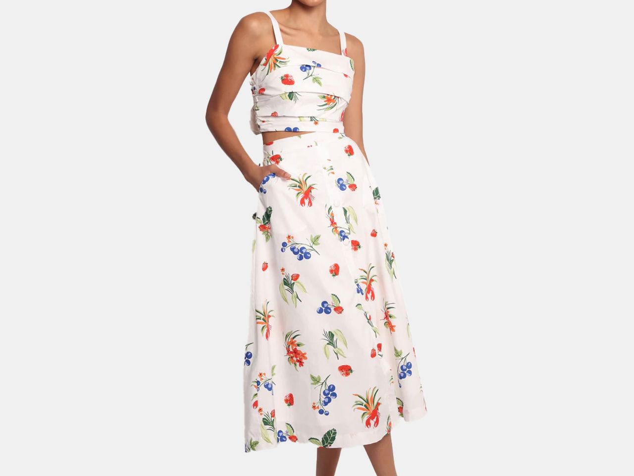 model in white two piece top and skirt