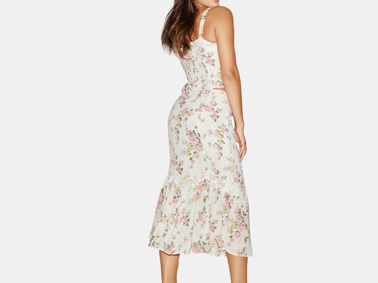 model in white and floral patterned tank top and skirt