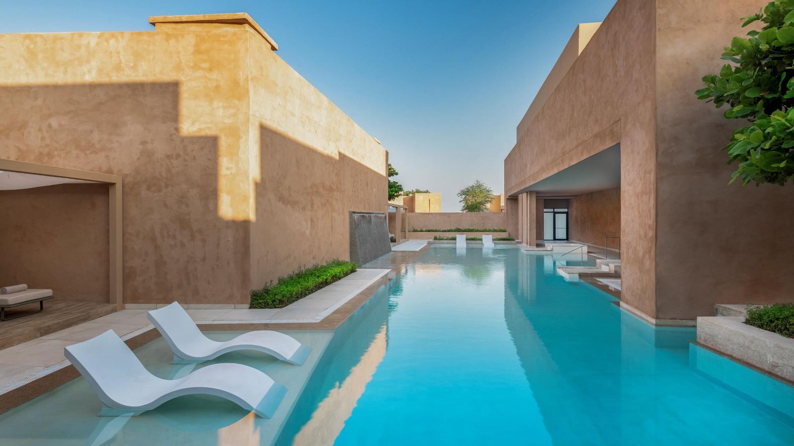 Image may contain Architecture Building House Housing Villa Pool Water Swimming Pool Chair Furniture and Outdoors