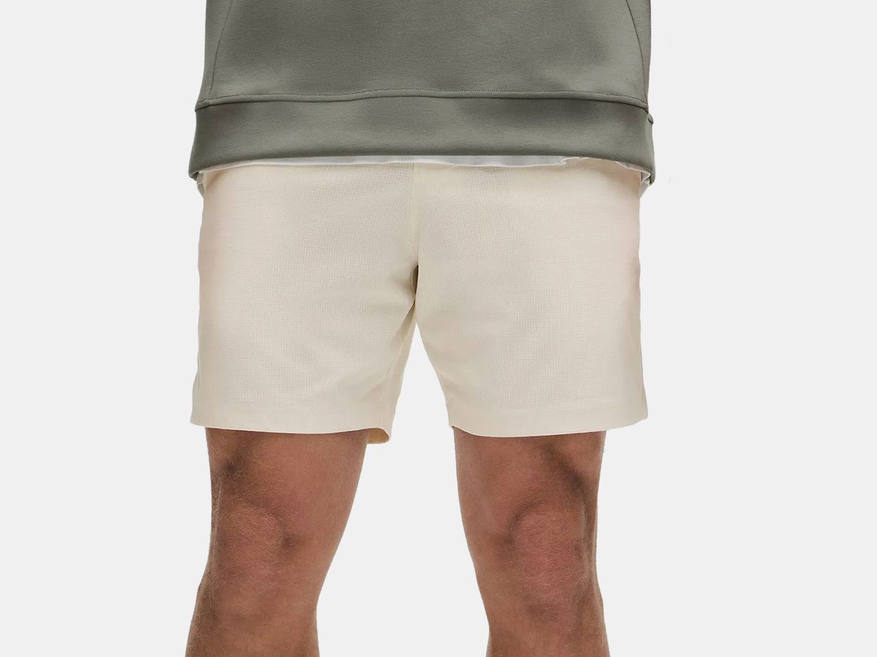 model in cream shorts