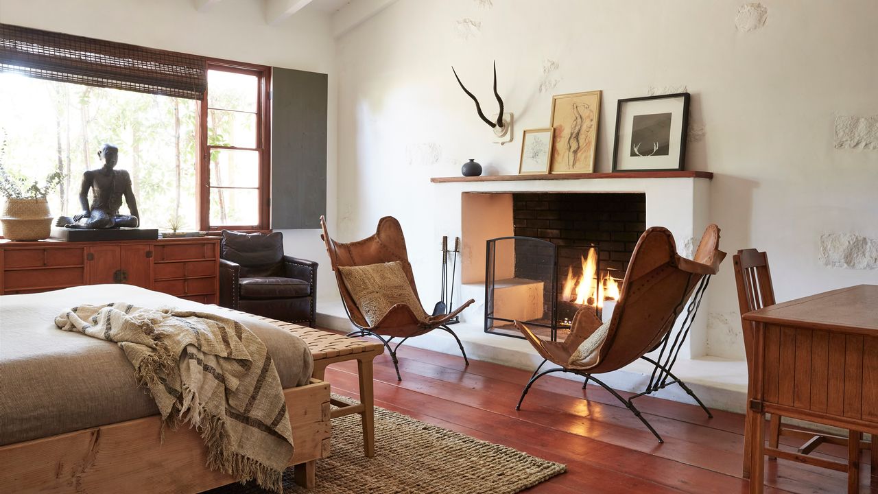 Image may contain: Home Decor, Fireplace, Indoors, Plant, Chair, Furniture, Bed, Person, Wood, Interior Design, and Art