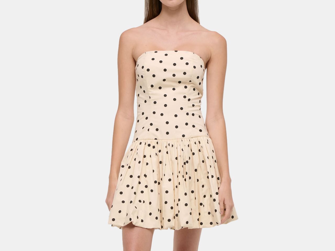 model wearing cream and black polka dot dress