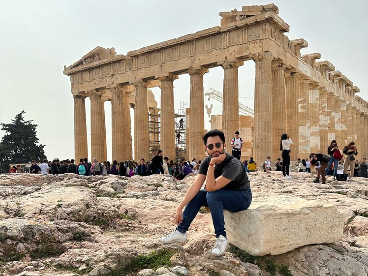 Associate editor Matt Ortile wearing his Stan Smiths in front of the Parthenon