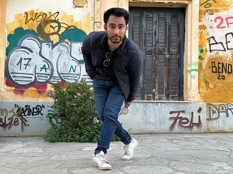 Ortile in front of graffiti in Plaka, a historic neighborhood in Athens, Greece