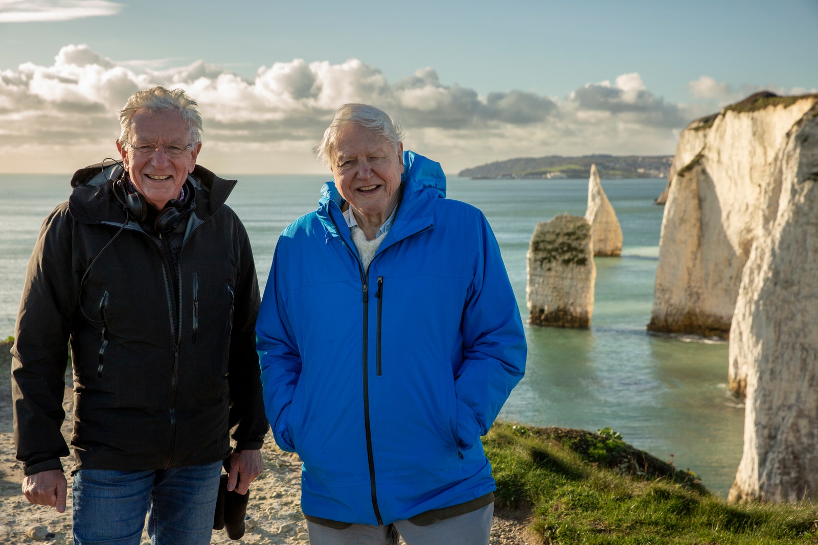Image may contain David Attenborough Oscar Goodman Clothing Coat Jacket Person Walking Adult and Electronics
