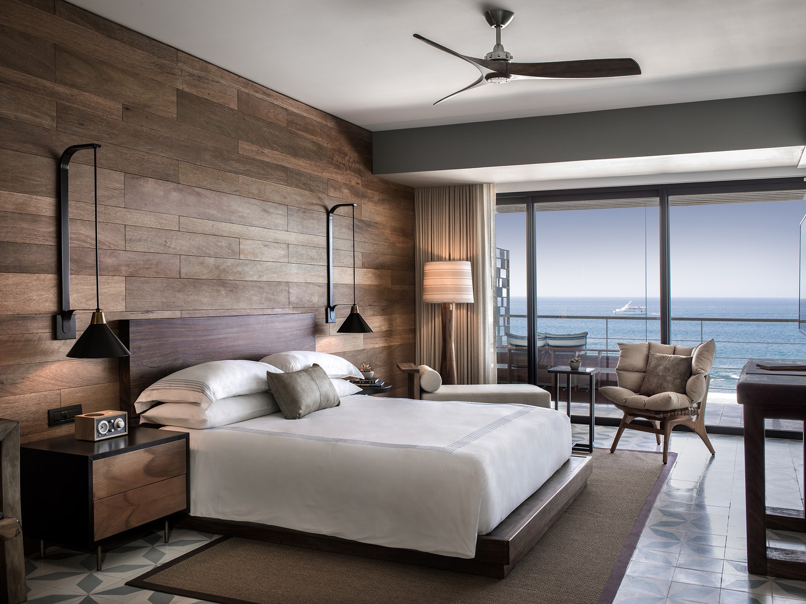 Image may contain Ceiling Fan Appliance Building Housing Indoors Interior Design Room Bedroom and Rug