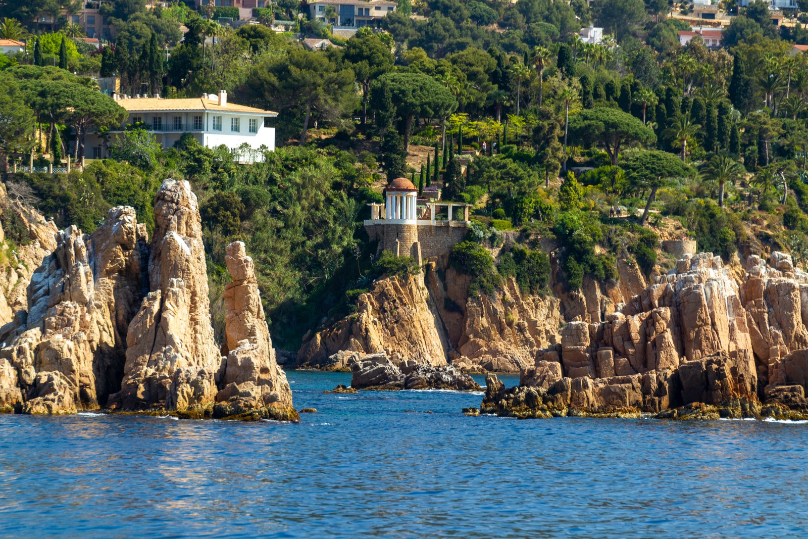 Image may contain Rock Nature Outdoors Scenery Land Sea Water Plant Vegetation Landscape Cliff and Shoreline