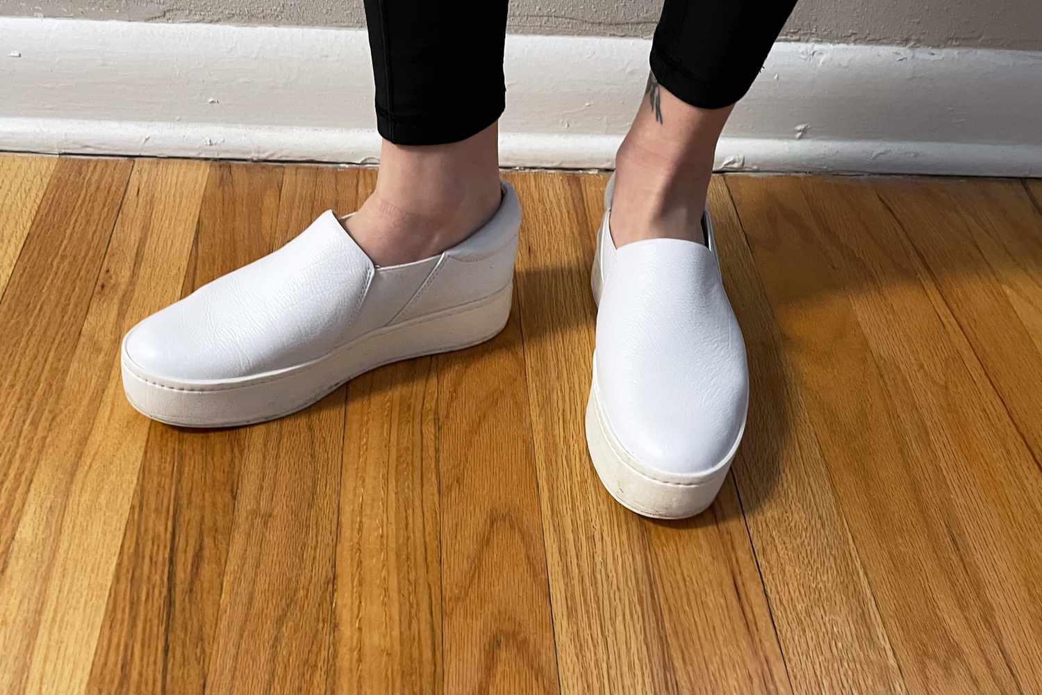 Closeup of person's feet wearing Vince Warren Suede Slip On Platform Sneakers