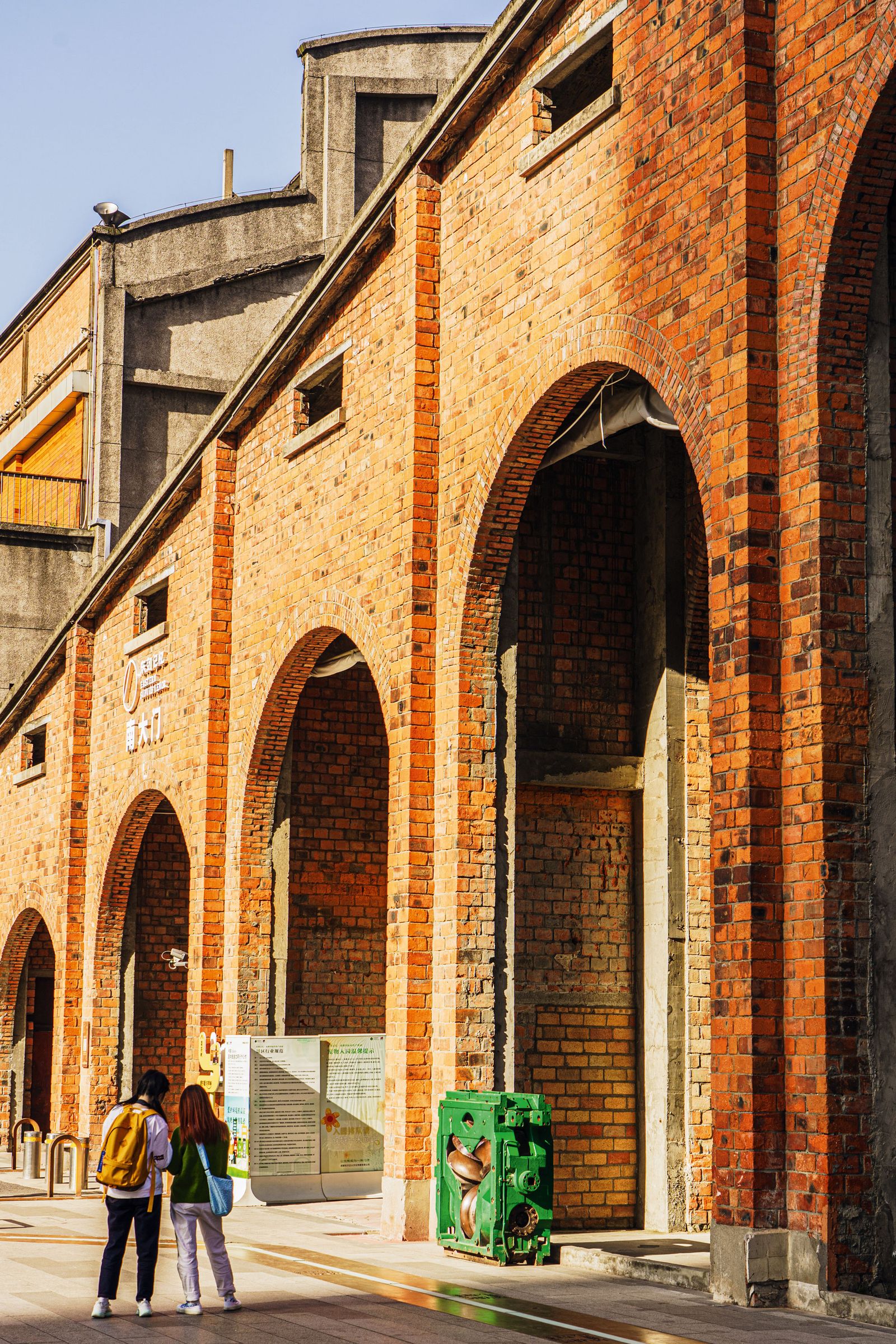Image may contain Brick Person Walking Backpack Bag Accessories Handbag City Road Street Urban and Clothing