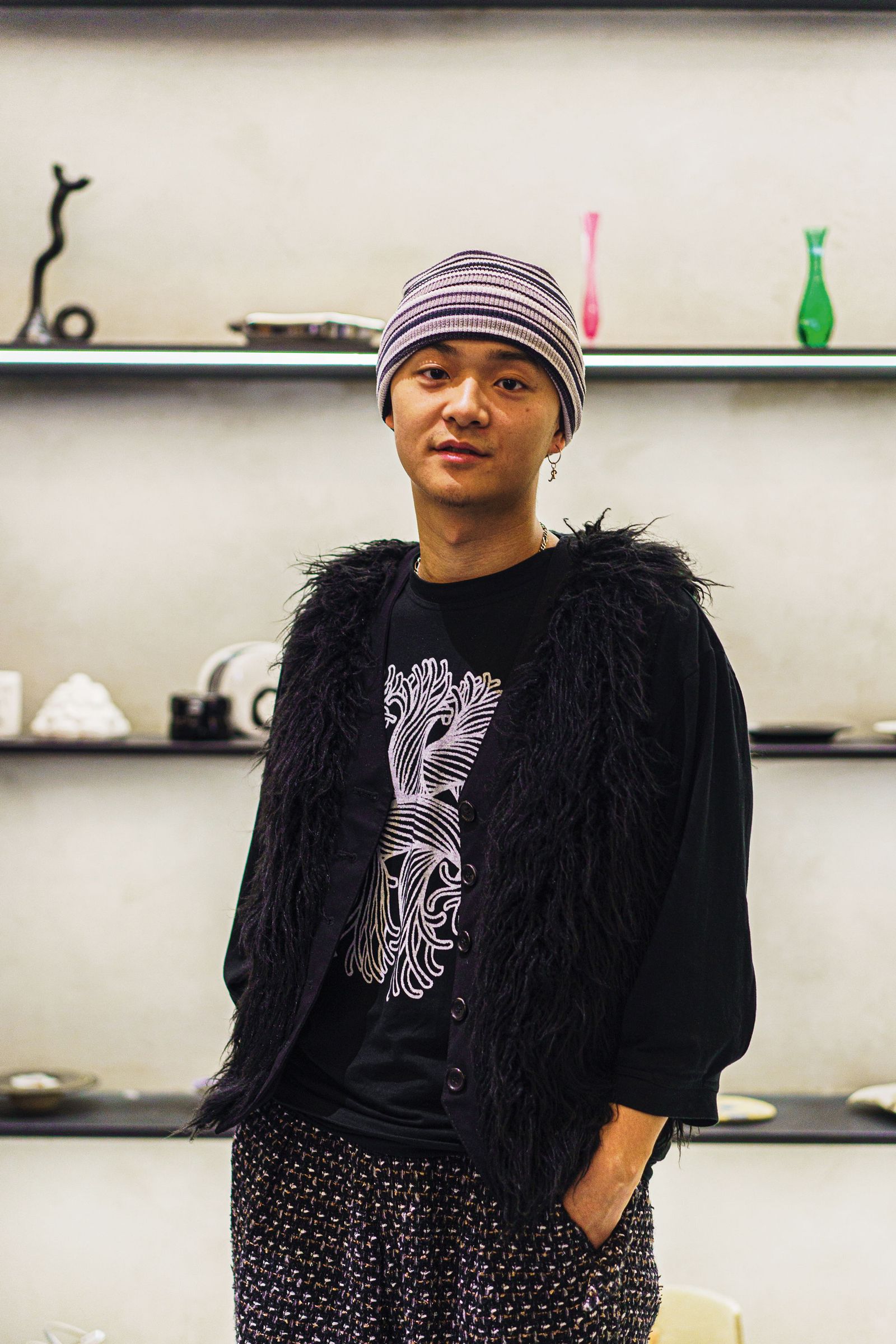Image may contain Cap Clothing Hat Adult Person Accessories Jewelry Necklace Cup and Plate