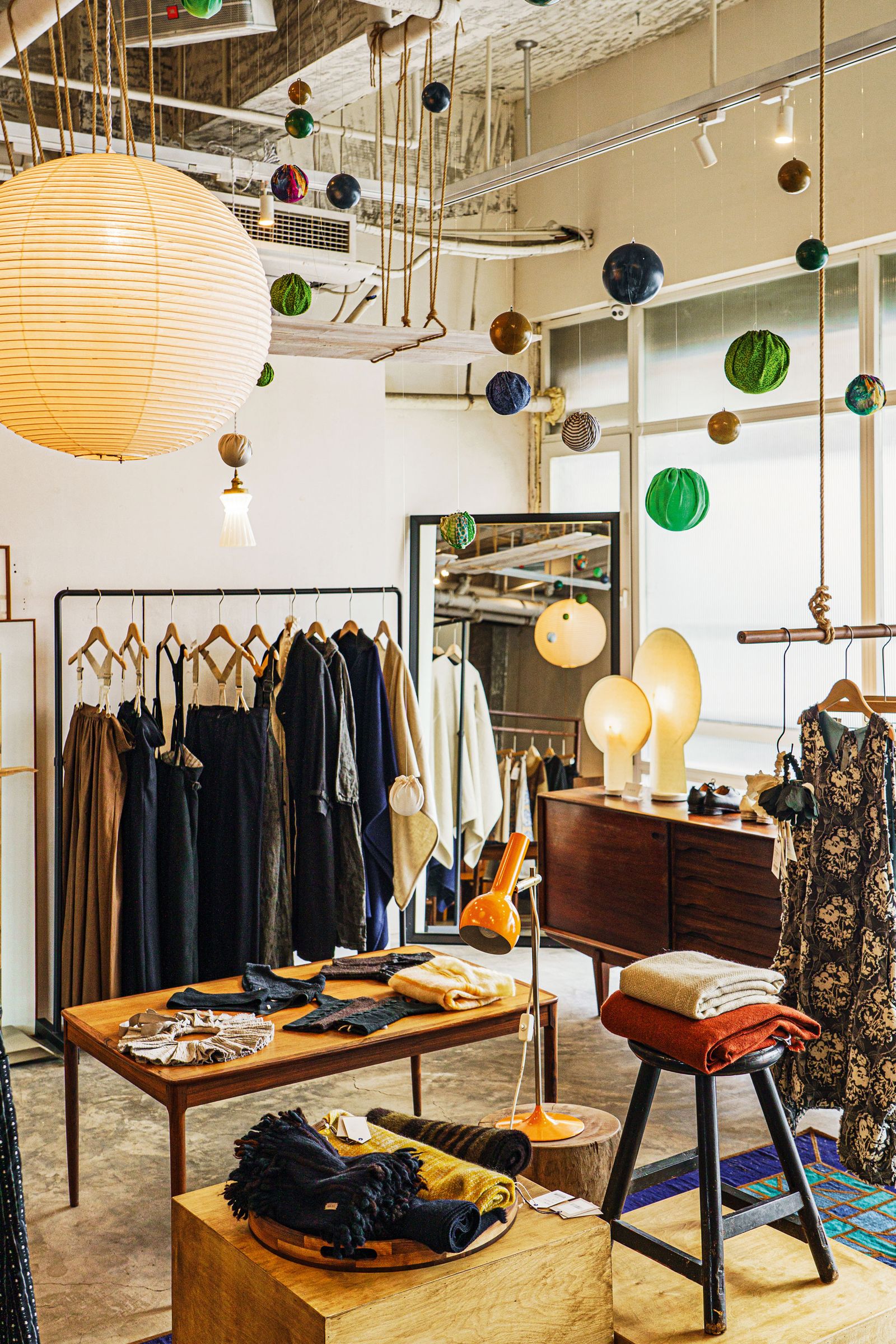 Image may contain Dressing Room Indoors Room Lamp Furniture Desk Table Shop Accessories Bag and Handbag