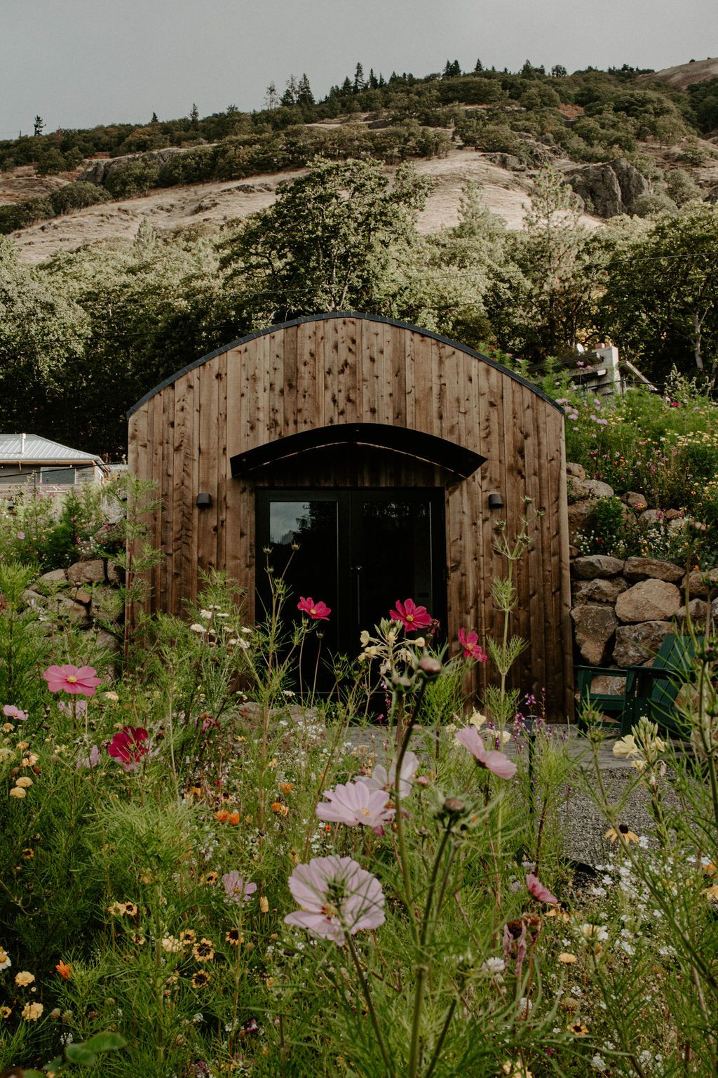Image may contain Architecture Building Outdoors Shelter Garden Nature Flower Geranium Plant Grass and Field