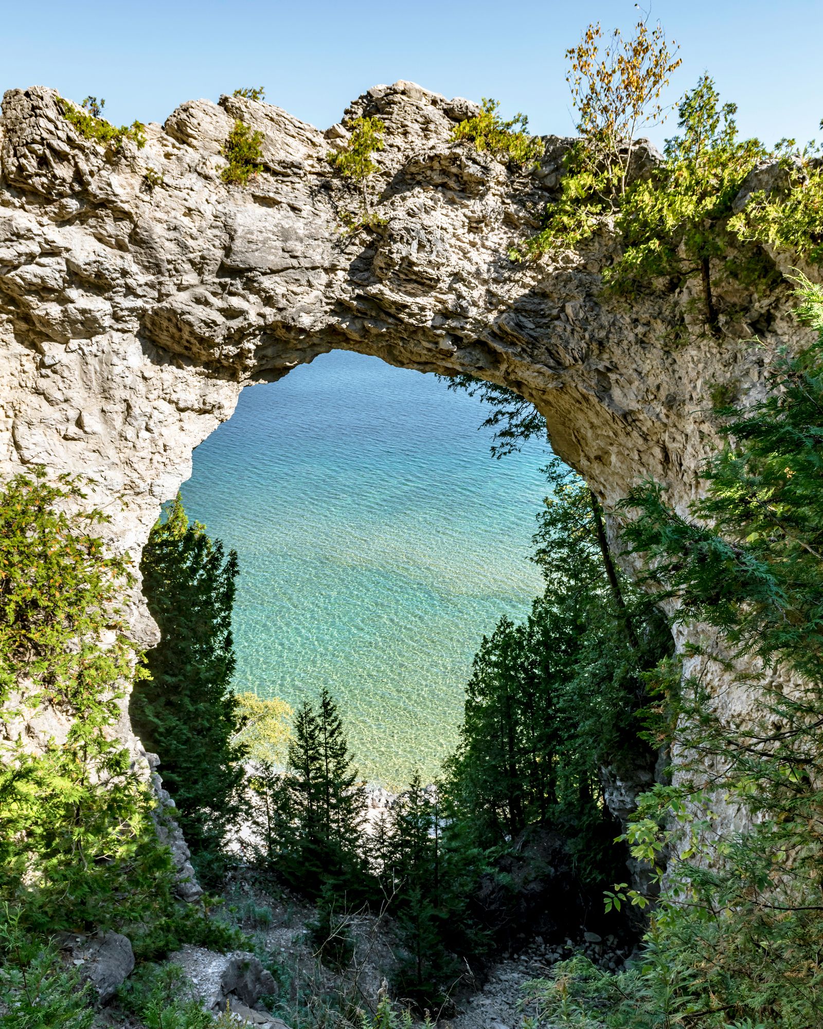 Image may contain Lake Nature Outdoors Water Rock Plant Vegetation Sea Scenery Lagoon Cliff Tree and Wilderness