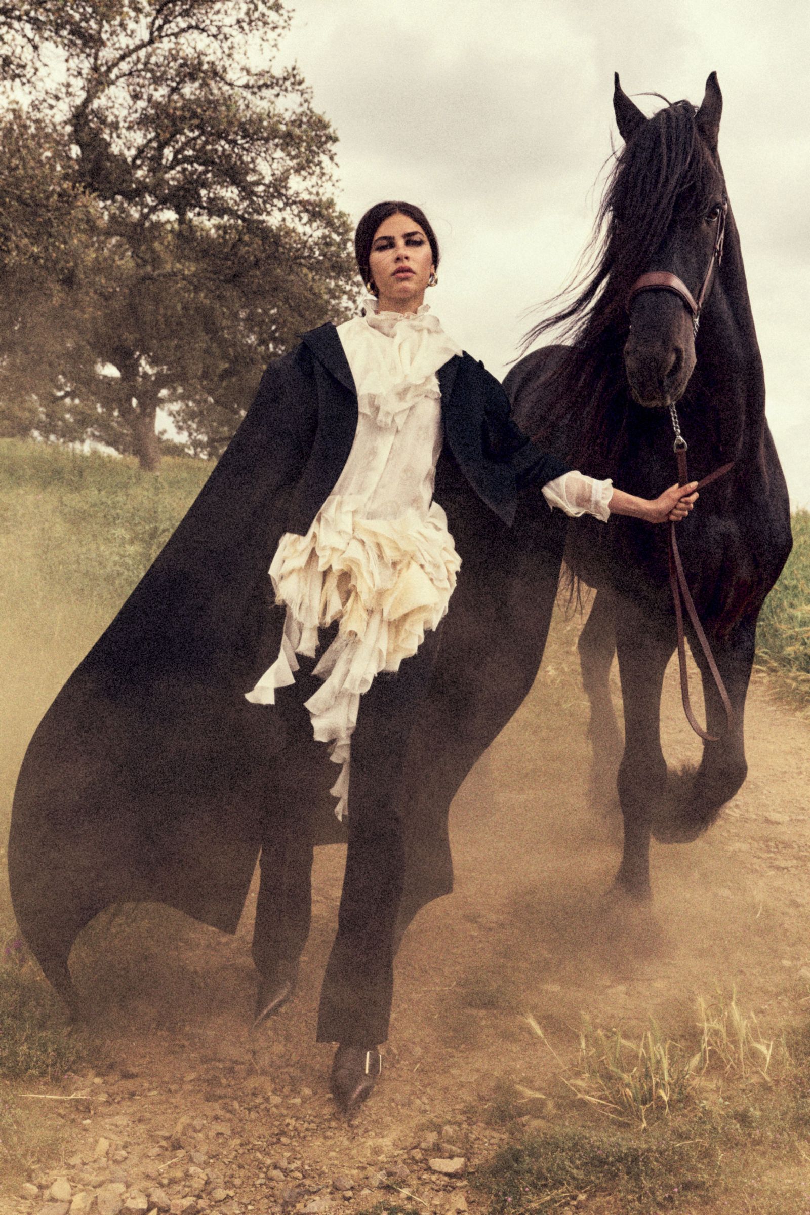 Image may contain Face Head Person Photography Portrait Fashion Clothing Costume Blouse Grass Plant and Footwear