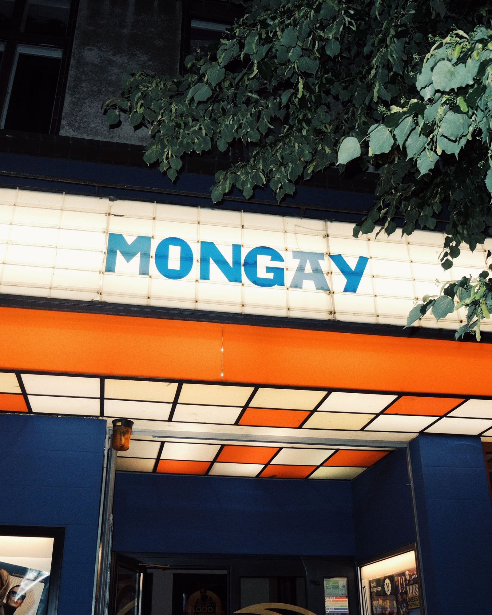 Exterior of Babylon Cinema at night with illuminated sign reading MONGAY