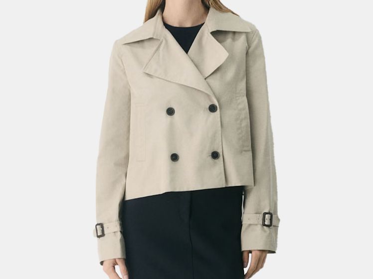 model wearing short, beige trench coat