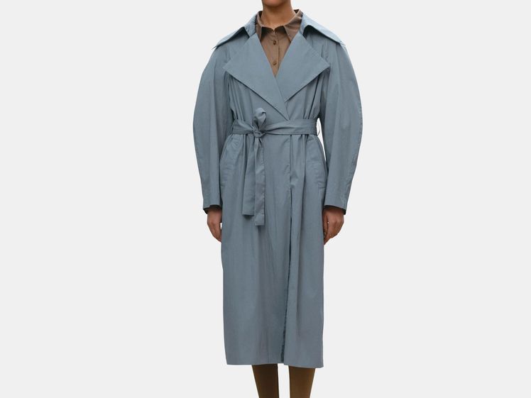 model wearing long stone blue trench coat