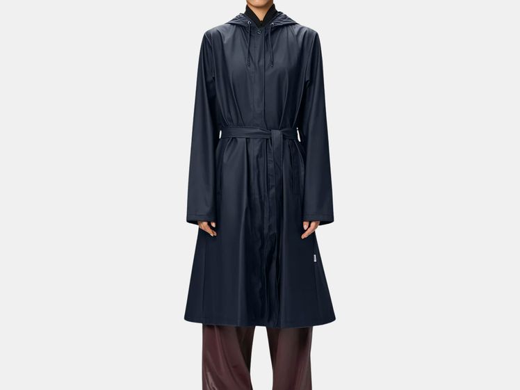 model wearing long, dark blue trench coat