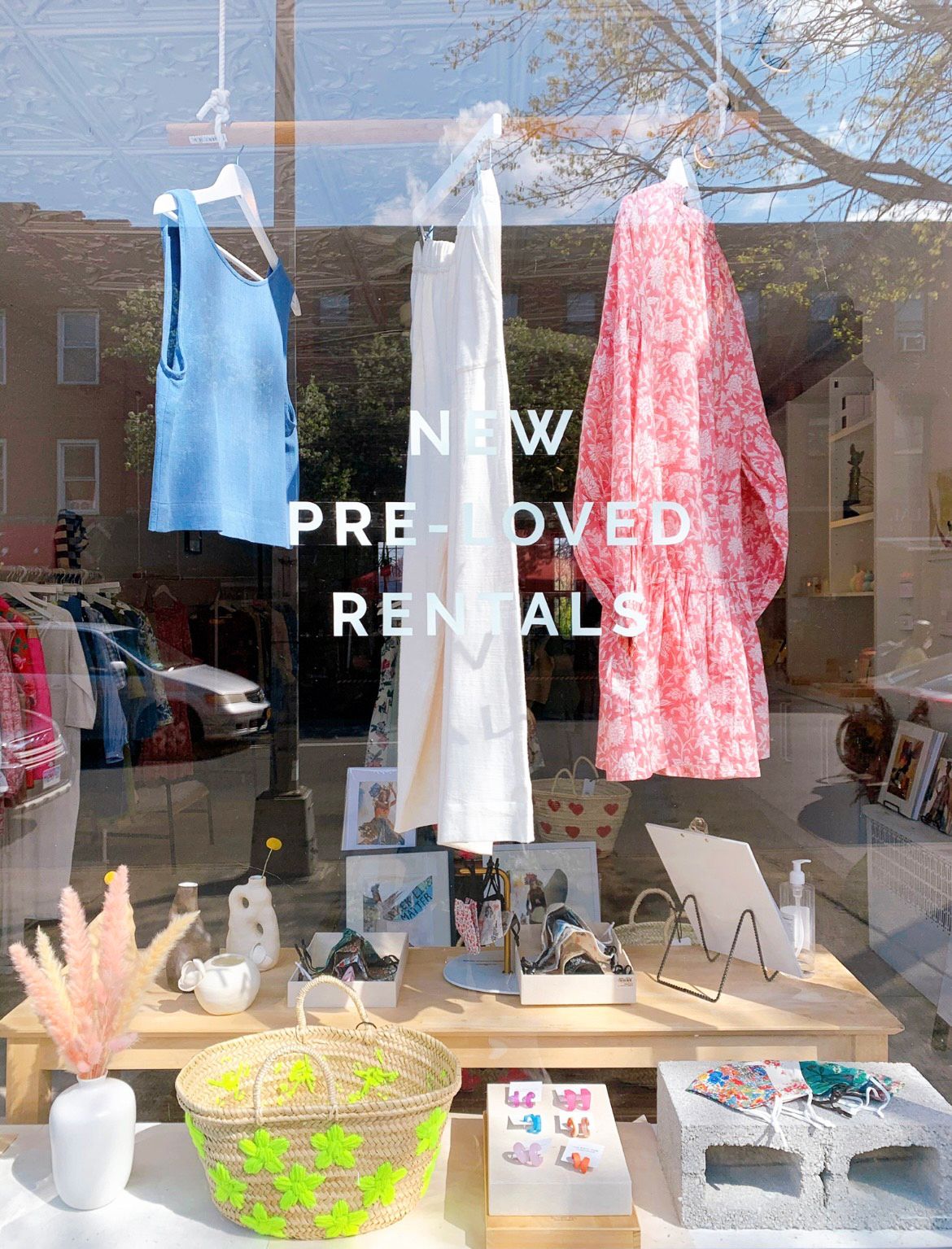 A merchandise display shown through the window of the store front at Rue Saint Paul