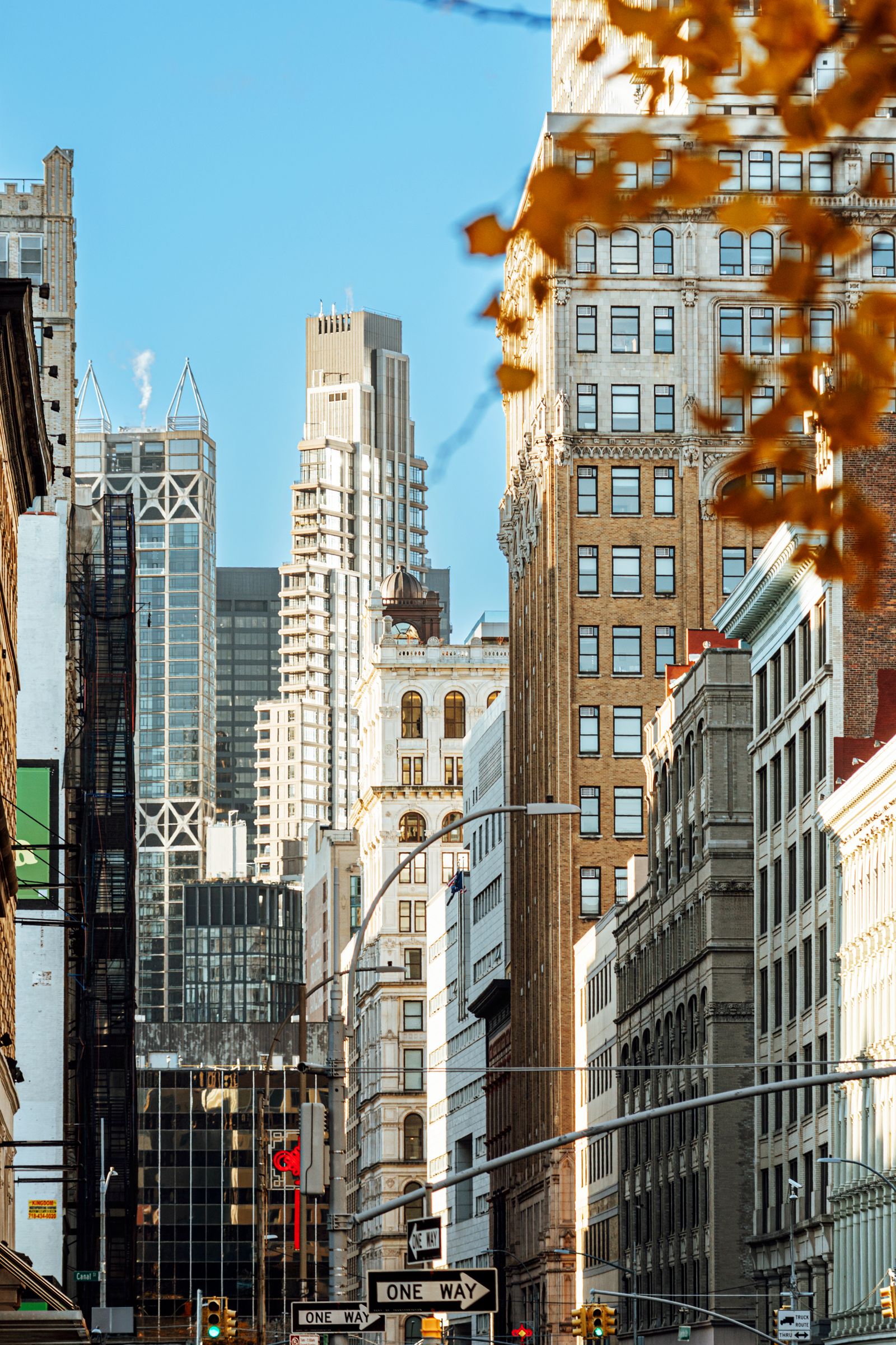 A bustling urban street scene in Manhattan's Soho district featuring historic architecture modern skyscrapers and...