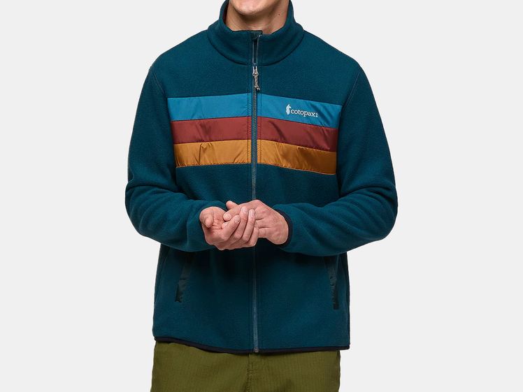 Blue fleece jacket with teal, red and orange striped across chest of male model.