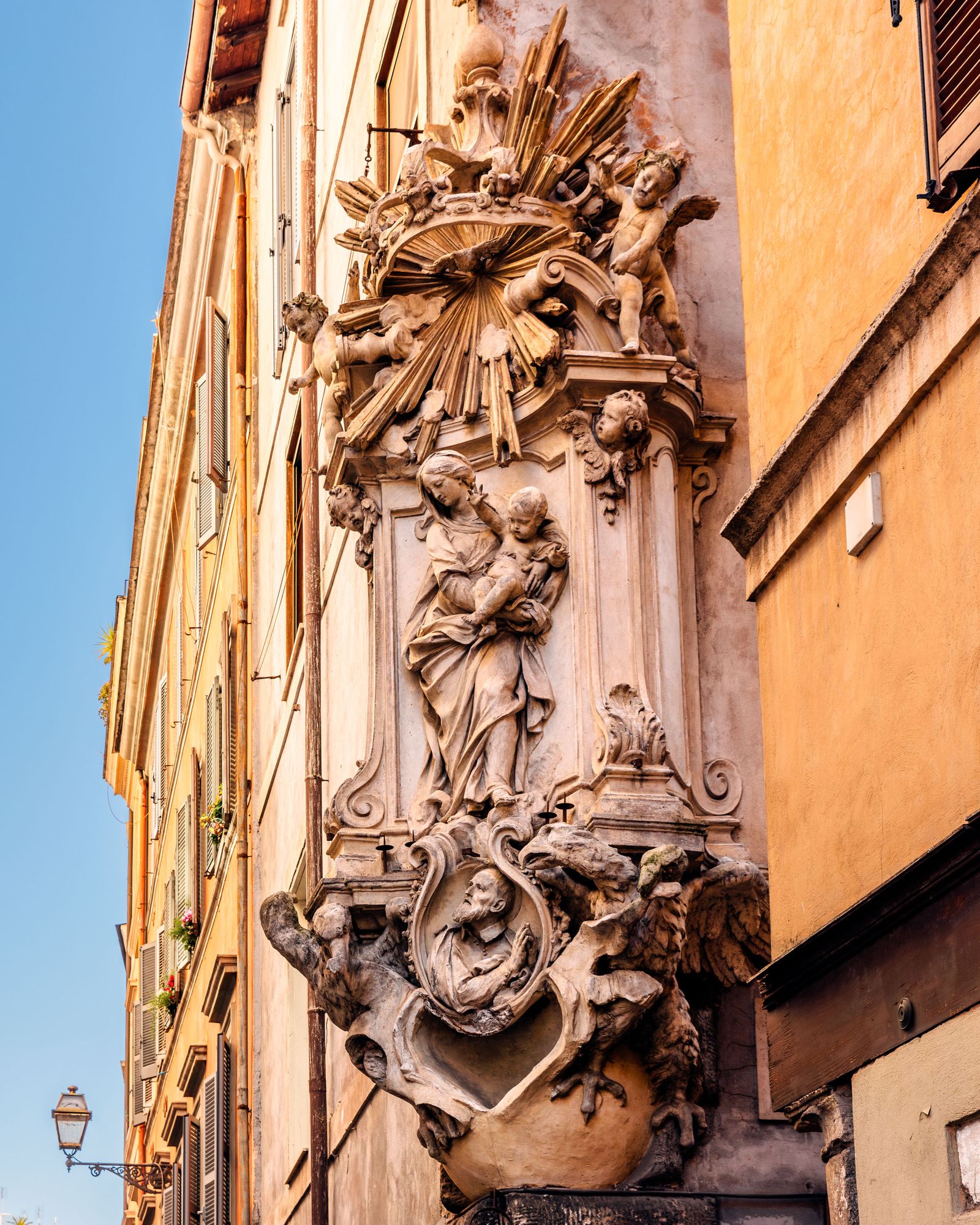 Closeup of a Madonnelle shrine on the exterior of a building in Rome