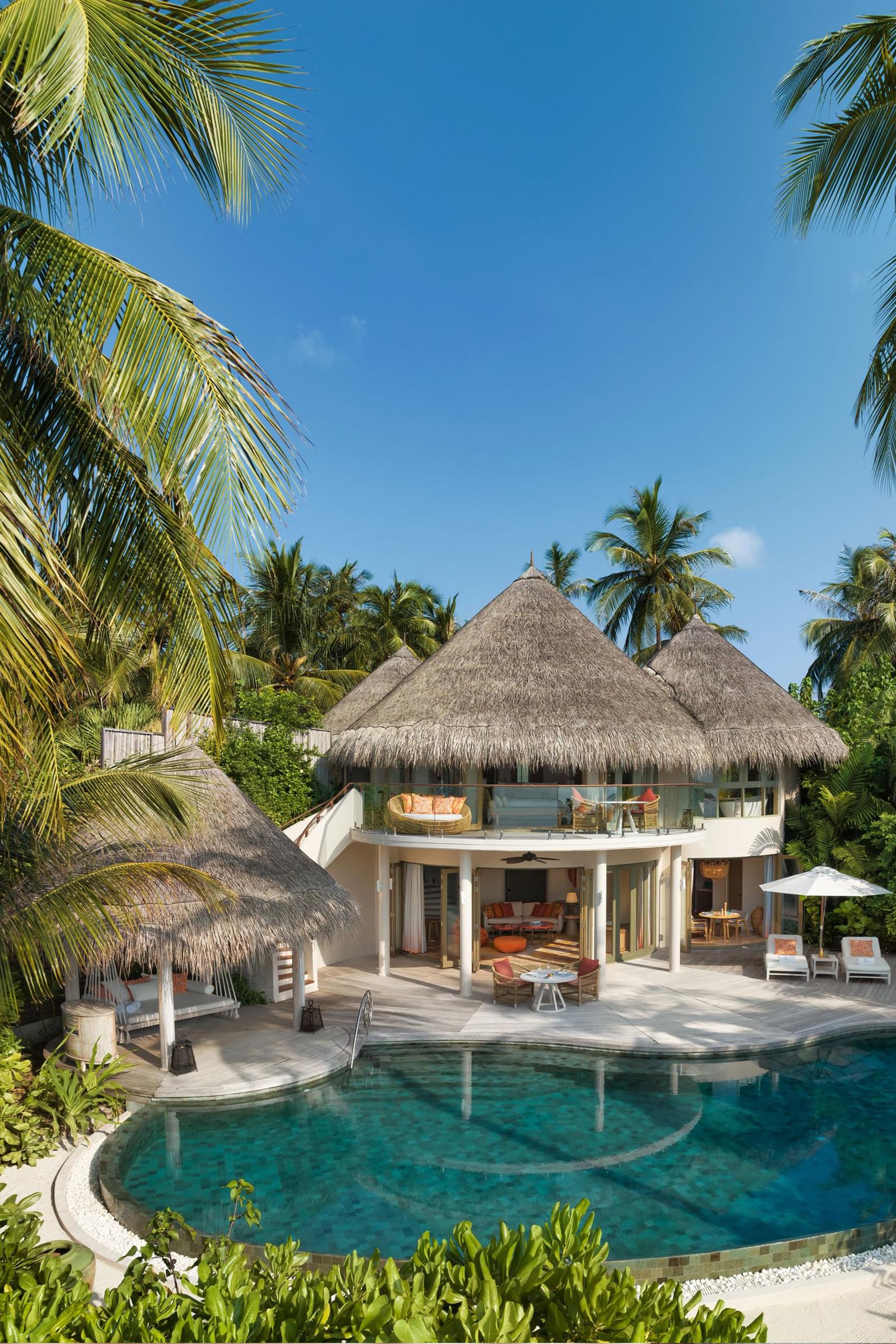 Image may contain Architecture Building Hotel House Housing Villa Resort Outdoors Pool Water Chair and Furniture