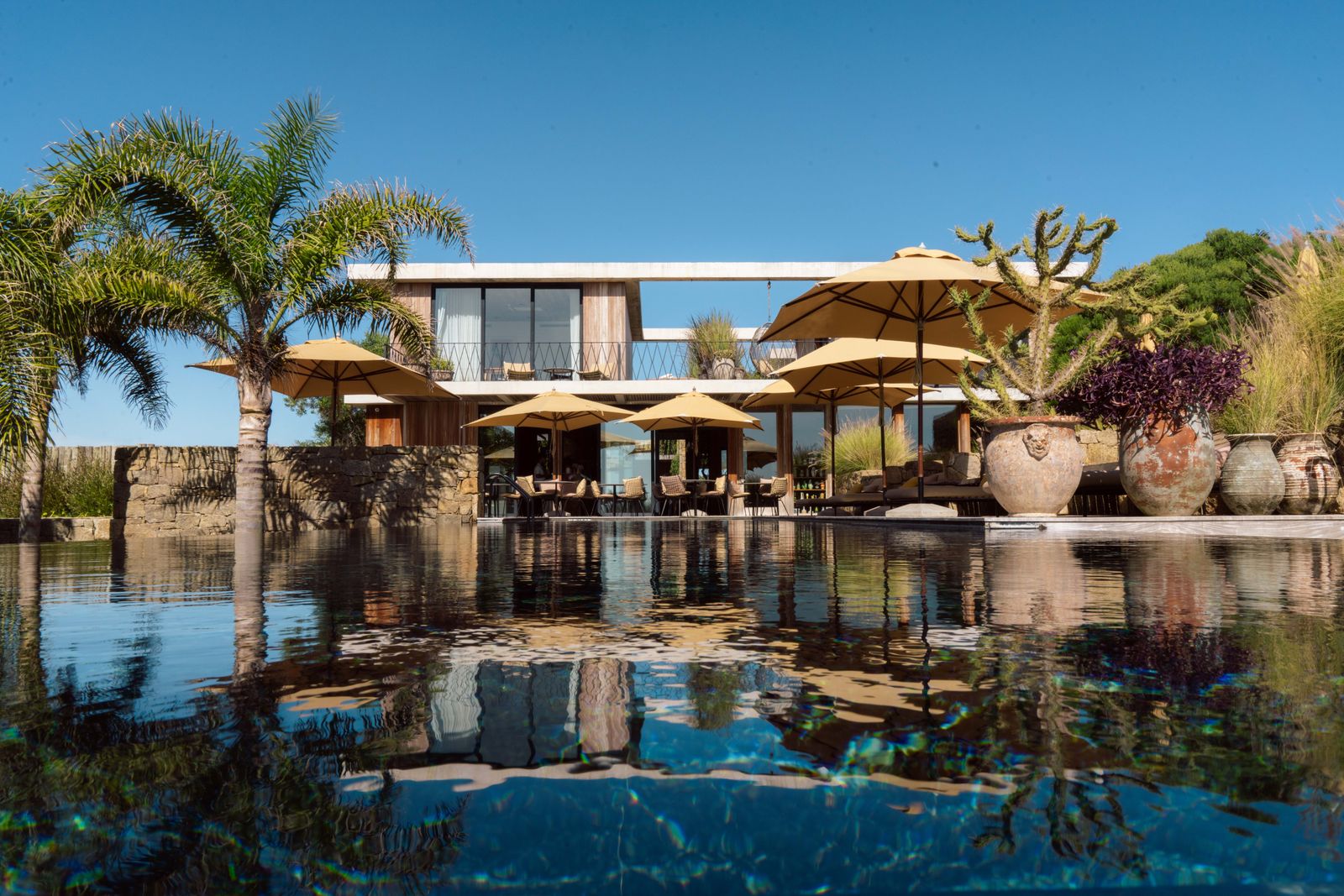 Image may contain Architecture Building House Housing Villa Hotel Pool Water Resort Swimming Pool and Waterfront