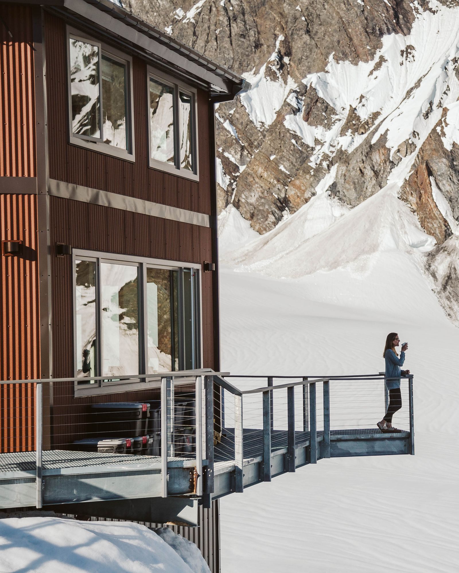 Image may contain Nature Outdoors Scenery Person Architecture Building Housing Clothing Glove Handrail and House