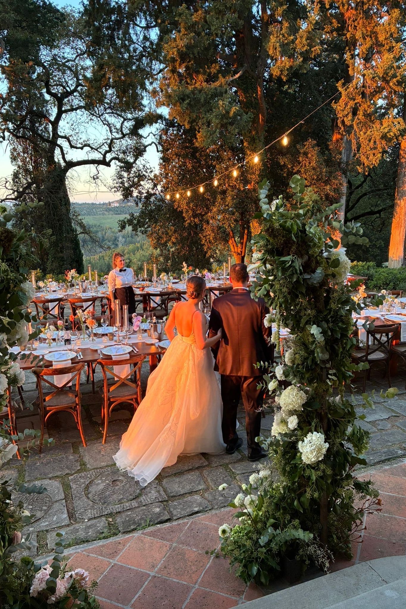 Image may contain Adult Person Wedding Clothing Dress Fashion Formal Wear Gown Wedding Gown Chair and Furniture