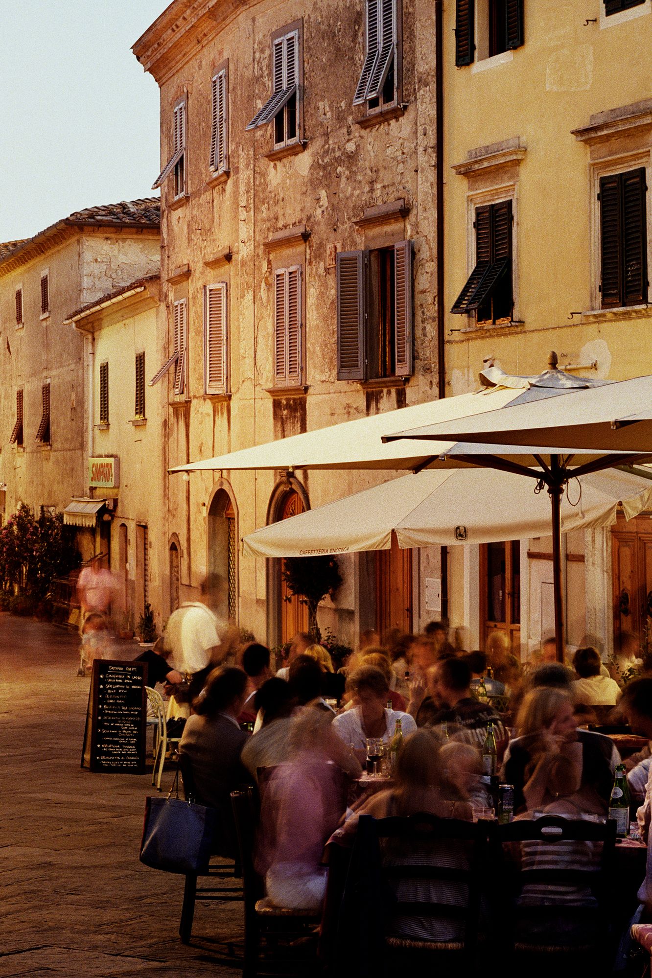 italian restaurant. People dining outside restuarants at dusk Italy Tuscany