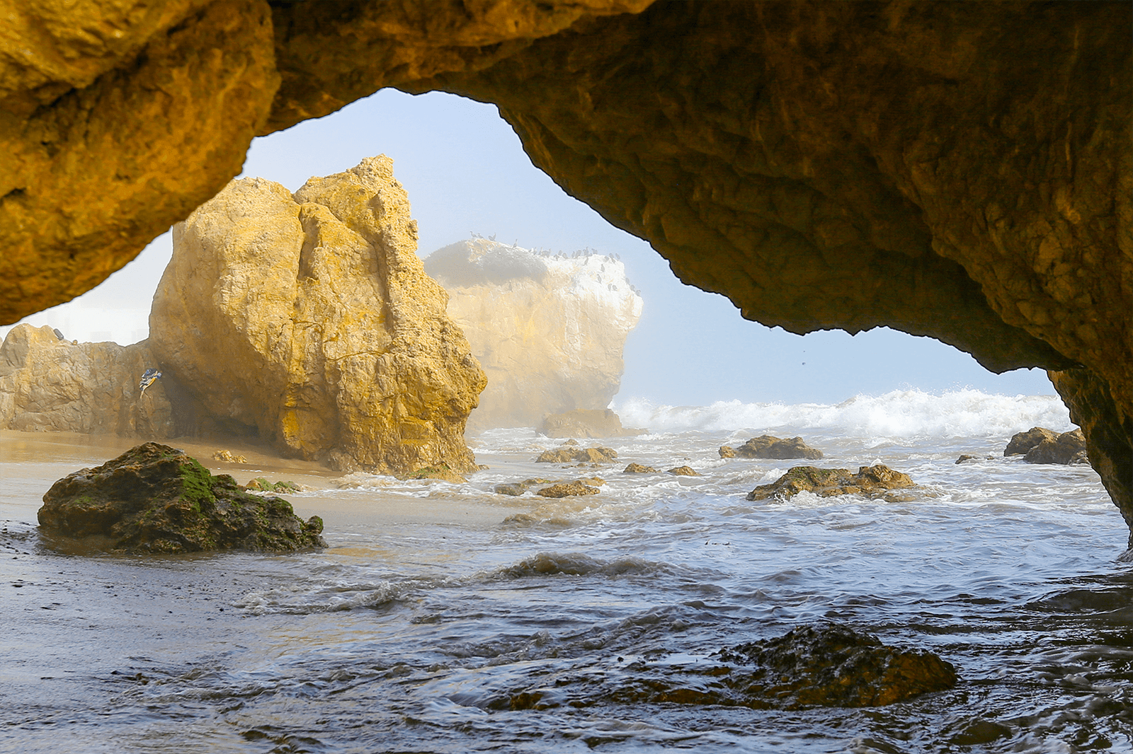 Image may contain Cave Coast Cove Nature Outdoors Sea Shoreline and Water