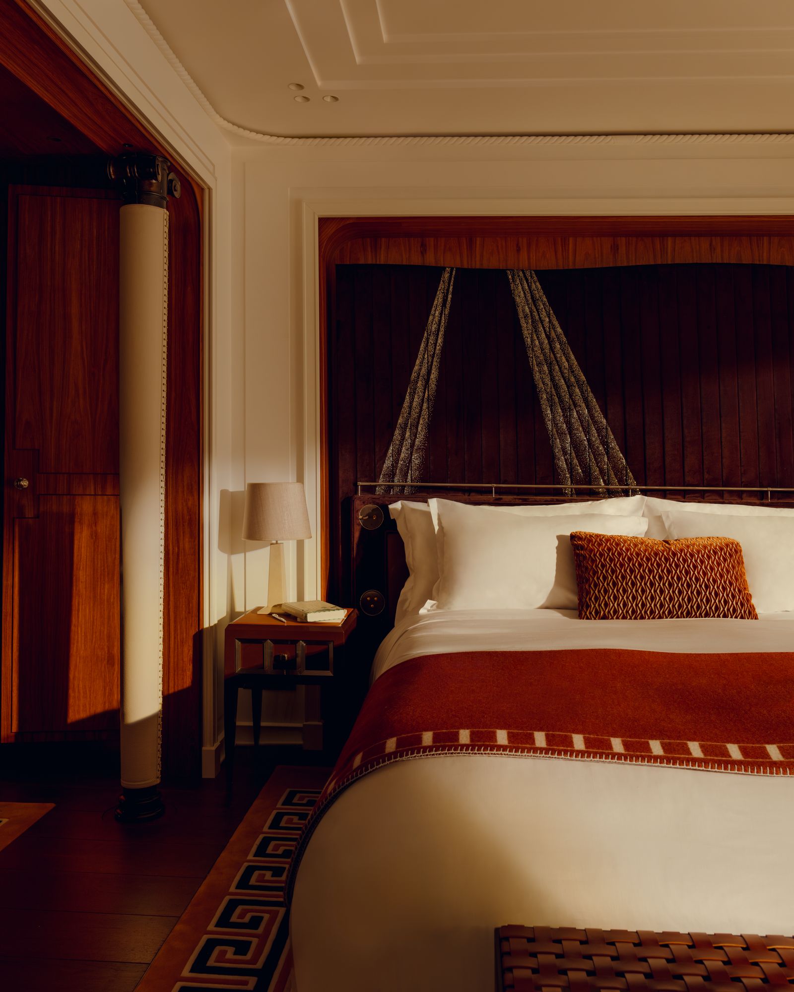 Image may contain Indoors Interior Design Architecture Building Hotel Resort Lamp Home Decor Bed and Bedroom