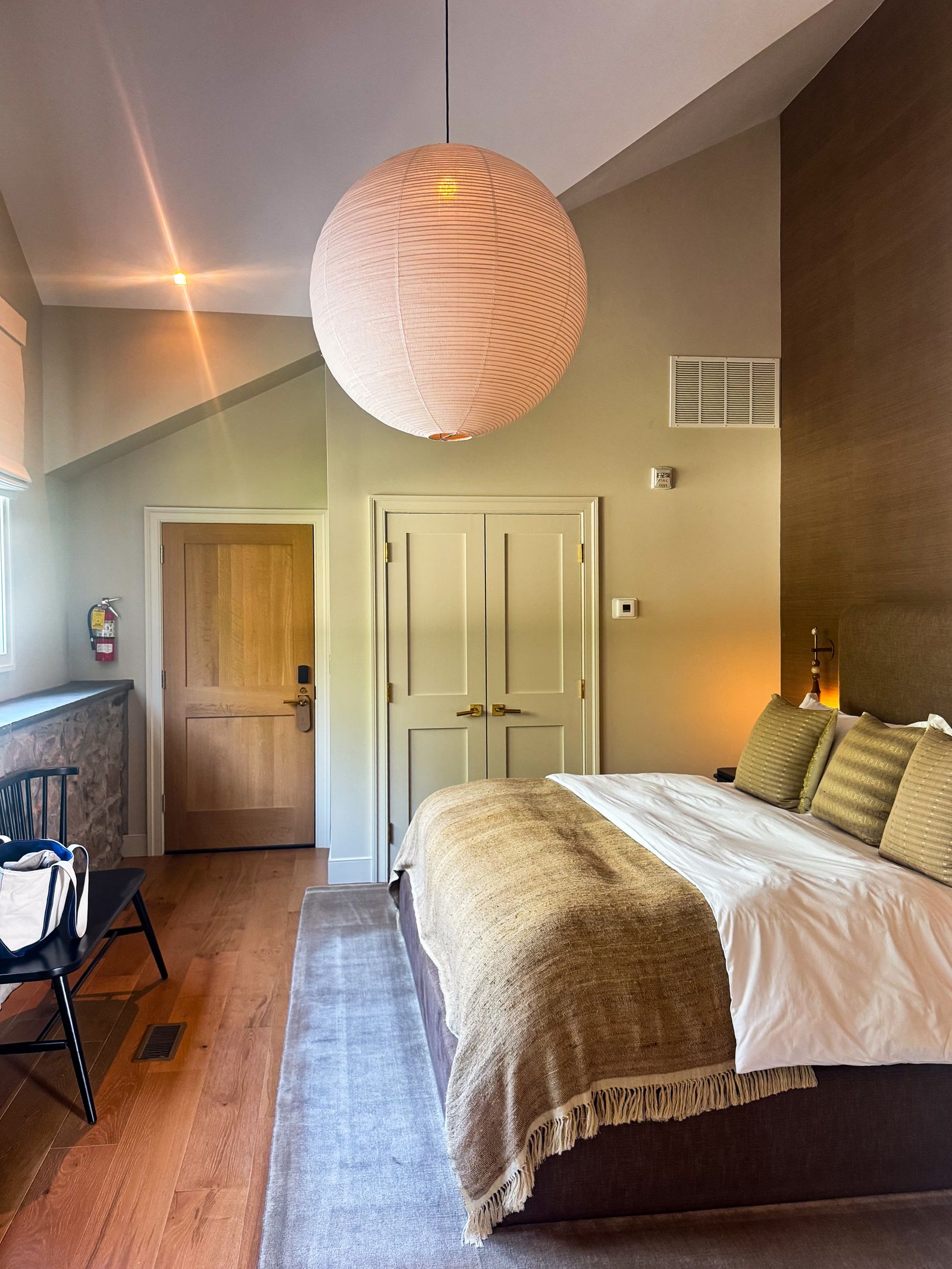 Image may contain Indoors Interior Design Home Decor Bed Furniture Lamp Floor Cushion Hardwood and Stained Wood
