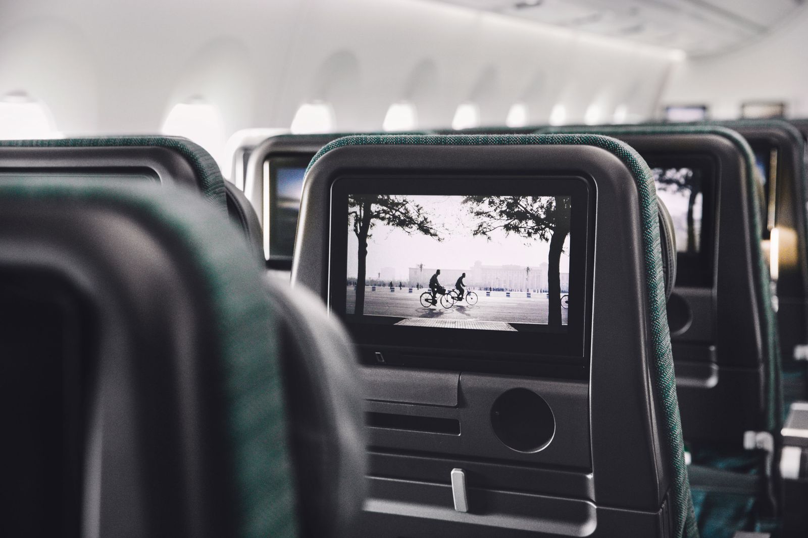 Entertainment consoles on seat headrests in Cathy's Economy Class